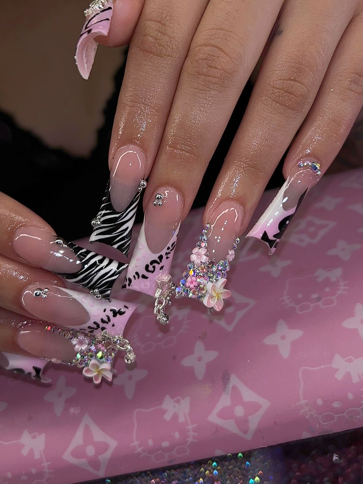 Zebra French set with rhinestone accents on a pink desk